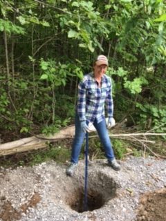 Breaking up stones for our new fence posts