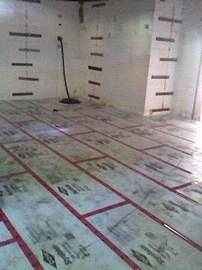 Basement floor ready for pipe to be installed in-floor heating.